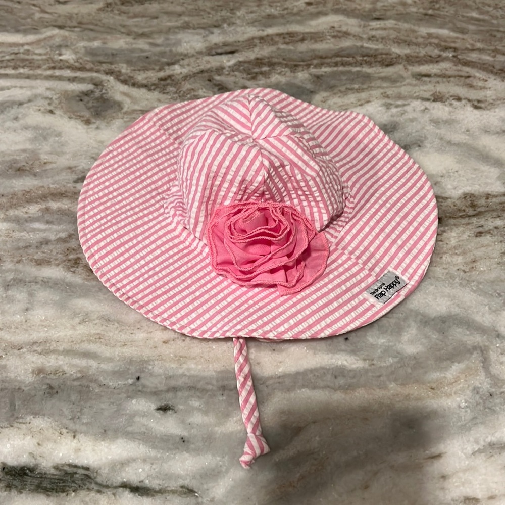 Pink and white stripped baby hat with pink bow.